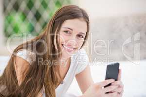 Portrait of smiling woman using mobile phone