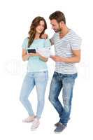 Worried couple calculating bill on calculator