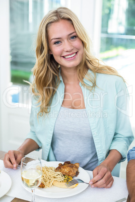 Portrait of happy woman having food