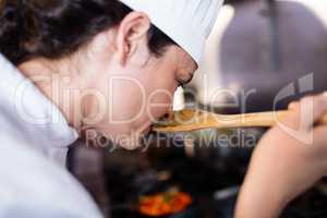 Chef smelling food in the kitchen