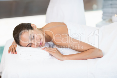 Woman relaxing on massage table at health spa