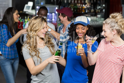 Happy friends drinking cocktails