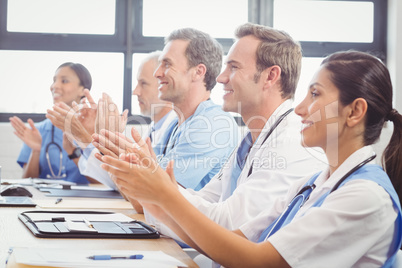 Medical team applauding in conference room