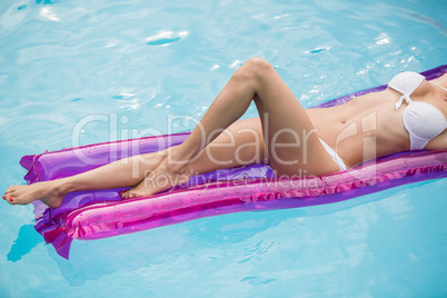 Beautiful young woman relaxing on inflatable raft