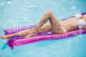 Beautiful young woman relaxing on inflatable raft