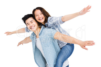 Young man giving piggyback ride to woman