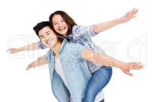 Young man giving piggyback ride to woman