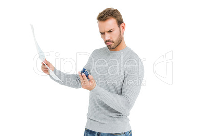 Young serious man holding a map