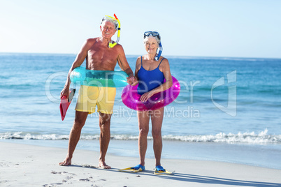 Senior couple with beach equipment