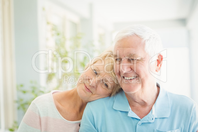 Happy senior couple smiling at home