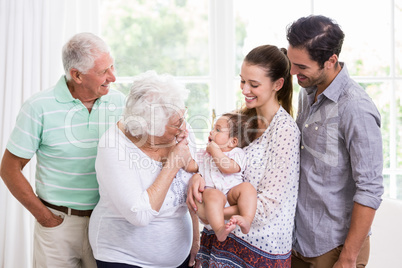 Smiling family playing with baby