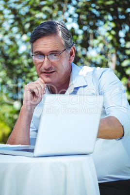 Mature man looking at laptop