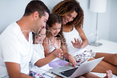 Family having video chat on laptop