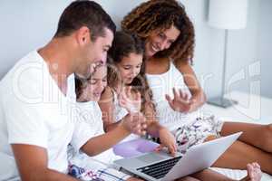 Family having video chat on laptop