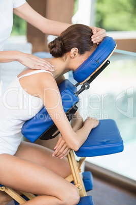 Side view of woman receiving back massage