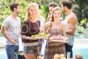 Friends preparing for outdoors barbecue party