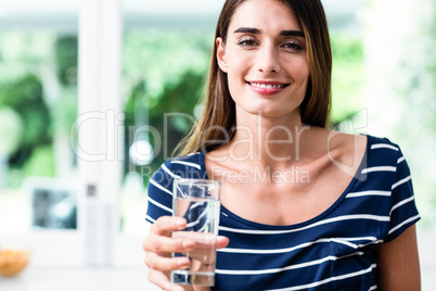 Portrait of smiling young woman with drinking water