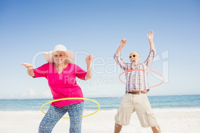 Senior couple doing hula hoop