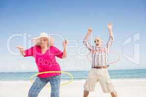Senior couple doing hula hoop