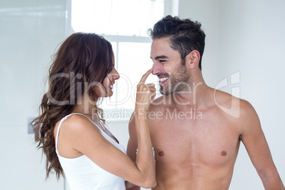 Wife applying cream on husband face