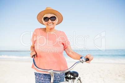 Smiling senior woman with her bike