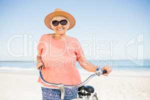 Smiling senior woman with her bike