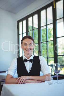 Waitress posing and sitting at the table