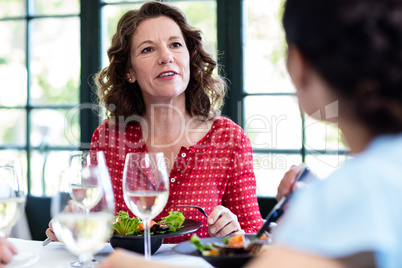 Friends talking while having lunch