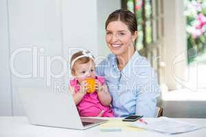 Woman sitting with baby by table