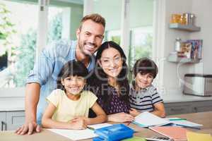 Parents assisting children doing homework