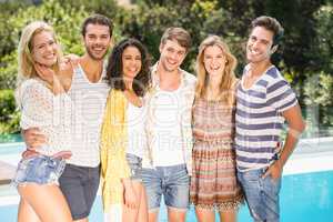 Portrait of friends standing near pool