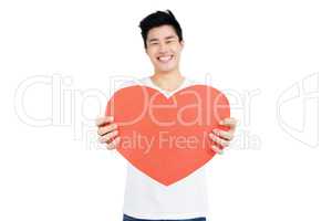 Young man holding heart shape