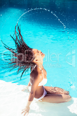 Beautiful woman tossing her wet hair