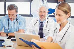 Male doctor using laptop in conference room