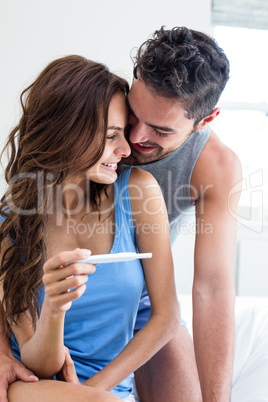 Happy romantic couple with pregnancy test