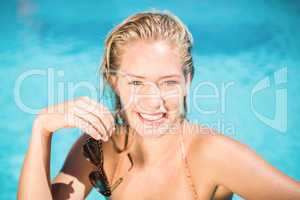 Portrait of beautiful woman leaning on poolside