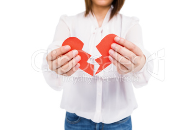 Young woman holding broken heart