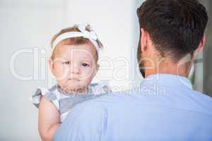 Portrait of cute baby girl with father