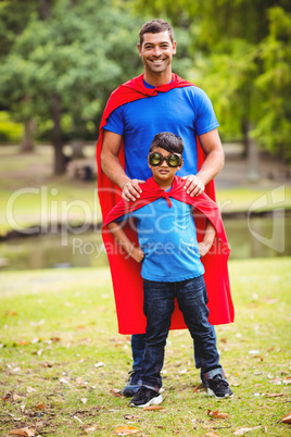 Father and son in superhero costume