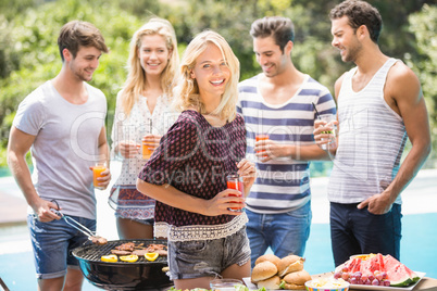 Group of friends preparing for outdoors barbecue party