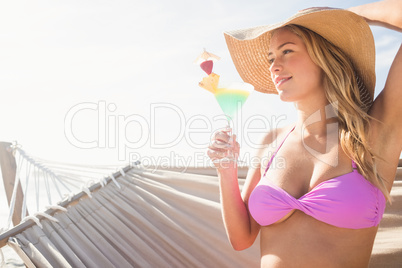 Woman drinking cocktail in hammock