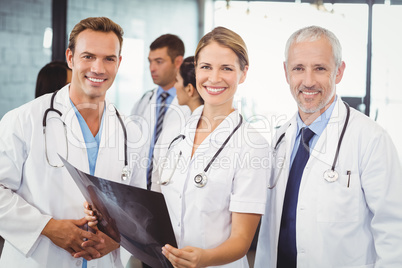 Portrait of medical team holding a x report