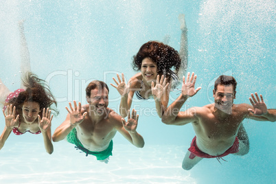 Portrait of cheerful friends swimming