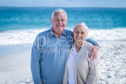 Senior couple standing ion the beach