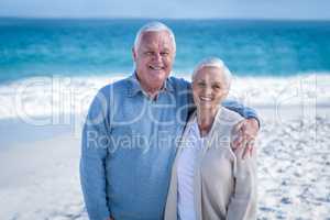 Senior couple standing ion the beach