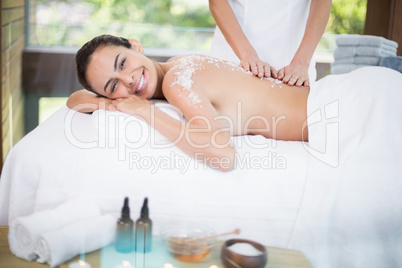 Young woman smiling while receiving spa treatment