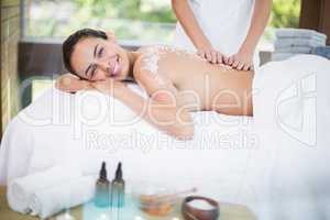 Young woman smiling while receiving spa treatment