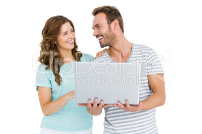 Happy young couple using laptop