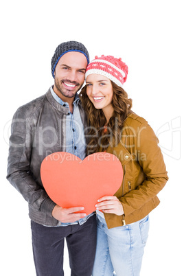 Young couple holding big heart