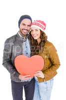 Young couple holding big heart